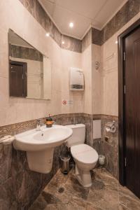 a bathroom with a toilet and a sink at Max Holiday Apartment in Pamporovo +3 photos
