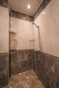 a bathroom with a shower with a glass door at Max Holiday Apartment in Pamporovo