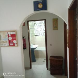 a bathroom with a sink and a bath tub at Apartamento Central in Vila Real de Santo António