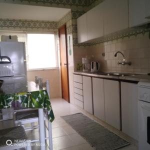 a kitchen with a sink and a counter top at Apartamento Central in Vila Real de Santo António