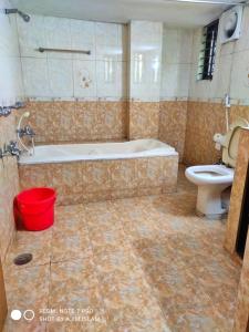 a bathroom with a bath tub and a toilet at Hotel Royal Avenue in Chittagong