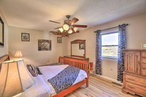 a bedroom with a bed and a ceiling fan at Pet Friendly Meadowview Retreat on Hobby Farm! in Meadowview