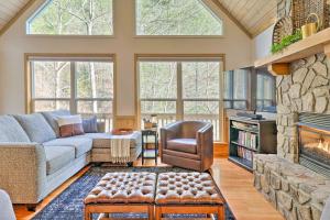 a living room with a couch and a fireplace at Idyllic Creekside Bryson City Gem with Fire Pit! in Bryson City