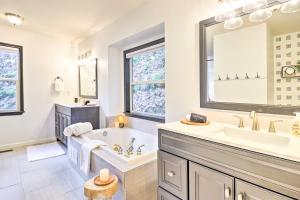 a white bathroom with a tub and a sink at Idyllic Creekside Bryson City Gem with Fire Pit! in Bryson City +23 photos