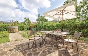 a table and chairs with an umbrella on a patio at VILLA ROGE' in Castellabate