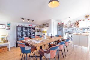 a dining room with a wooden table and chairs at Apartmani Lucija in Poreč