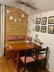 uma sala de jantar com uma mesa de madeira e cadeiras em Jefimija em Jasikovice