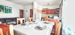 a kitchen and dining room with a table and chairs at Beach Inn in Quarteira