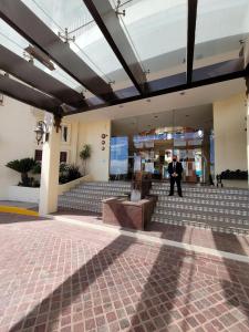 a man standing in the lobby of a building at Hotel Quinta las Alondras in Guanajuato