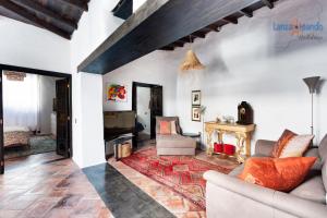 a living room with a couch and a fireplace at Vivienda Vacacional El Patio de Franky in Teguise