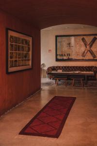 a living room with a bench and a rug at Casa Carmen Reforma in Oaxaca City