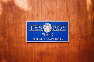 a sign on a wooden door that reads tesros mexico huts at Casa Carmen Reforma in Oaxaca City