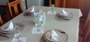 a white table with plates and glasses on it at Beach Inn in Quarteira