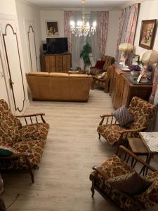 a living room with a large couch and chairs at Gîte de l’Allaine in Morvillars