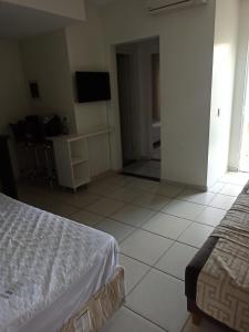 伊比亞巴斯的住宿－Village Aldeia das Águas，卧室配有1张床,铺有瓷砖地板。