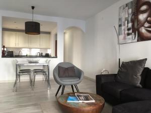 a living room with a couch and a table at Poseidons Pearl Duquesa in Manilva