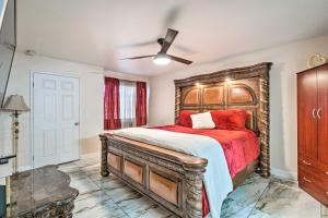 a bedroom with a bed with a wooden headboard at Seasonal Pool and Spa Las Vegas Pad, 11 Mi to Strip in Las Vegas