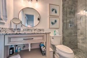 a bathroom with a sink and a toilet and a mirror at Pet-Friendly Lake Sinclair Home with Boat Dock! in Eatonton +18 photos