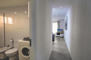 a bathroom with a toilet and a washing machine at N E W 2021 My-Lanza the Luxury ONE in Costa Teguise +16 photos
