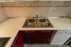 a kitchen counter with a sink in it at Apartmani Jasna in Herceg-Novi +48 photos