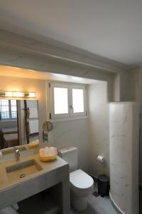 a small bathroom with a toilet and a sink at FAMILY in Spetses