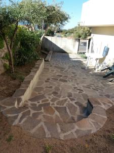 a stone walkway with chairs on the side of a house at nonna antonietta in San Teodoro
