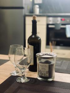 a bottle of wine and two wine glasses on a table at Vanilla Ice apartment in Varna City