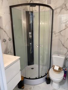 a bathroom with a shower and a toilet at Vue sur l’eau in Cap d'Agde +15 photos