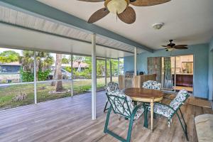a dining room with a ceiling fan and a table and chairs at Sunny Naples Home with Pool, Direct Gulf Access in Naples