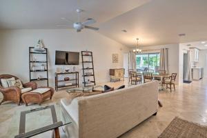a living room with a couch and a dining room at Sunny Naples Home with Pool, Direct Gulf Access in Naples