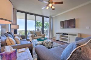 a living room with two couches and a flat screen tv at Sunny 1st-Floor Condo with Ocean-View Balcony! in Dauphin Island