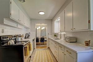 a kitchen with white cabinets and a stove top oven at Wilson Circle in Boise