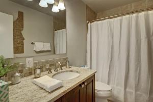 a bathroom with a sink and a toilet and a mirror at Wilson Circle in Boise +26 photos