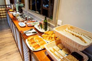 a buffet line with bread and baskets of food at Miss Sophie's Charles Bridge in Prague