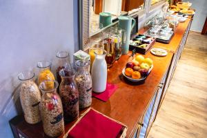 a long wooden counter with vases and fruit on it at Miss Sophie's Charles Bridge in Prague