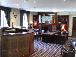 a hotel lobby with a bar and a waiting room at Northern Hotel in Brechin