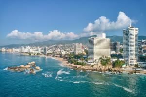 a large body of water with buildings at Fiesta Americana Acapulco Villas in Acapulco