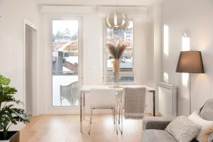 a living room with a table and chairs and a window at Donosti Deluxe in San Sebastián