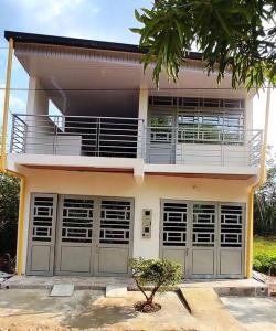 une maison avec deux portes de garage et un balcon dans l'établissement Hermoso apartamento con servicios y garaje., à Florencia