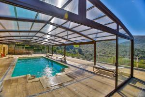 an indoor pool with a glass roof with a view at La Posada de Ojébar Rústica in Rasines