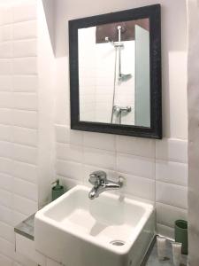 a white sink in a bathroom with a mirror at Your Apartment in Il-Furjana +44 photos