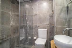 a bathroom with a shower and a toilet and a sink at Casa 36 Exquisite Flat in Lisbon