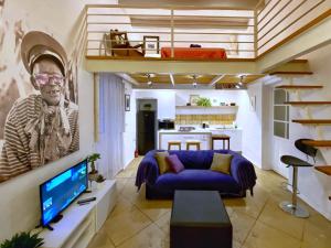 a living room with a blue couch and a tv at Your Apartment in Il-Furjana
