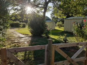 a wooden fence in front of a yard at DANS LA MAISON D'A COTE in Azerables