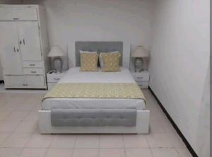 a bedroom with a large bed and two night stands at 1IF2-2APARTAMENTO EN CARTAGENA CERCA AL MAR CON AIRE ACONDICIONADO Y WIFi in Cartagena de Indias