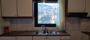 A kitchen or kitchenette at Anilio Rooms