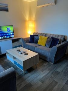 a living room with a couch and a coffee table at Bright and modern 2 bedroom home in Kirkwall in Kirkwall