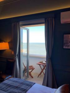 a bedroom with a window with a view of the ocean at Rambla Montevideo in Montevideo