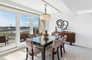 a dining room with a table and chairs and a large window at Bahia Mar Solare Tower 6th floor Bayview Condo 2bd 2ba with Pools and Hot tubs in South Padre Island