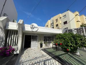 a building with a sign on the front of it at MonDieu Hostel in Barranquilla